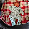 Lincoln joined the competition — help win amazing prizes! baby, newborn, sleeping, blanket, plaid, onesie, dinosaur_print, bassinet, cozy, infant, soft, cute, peaceful, child, nursery, resting, indoor, fabric, comfort, wearing