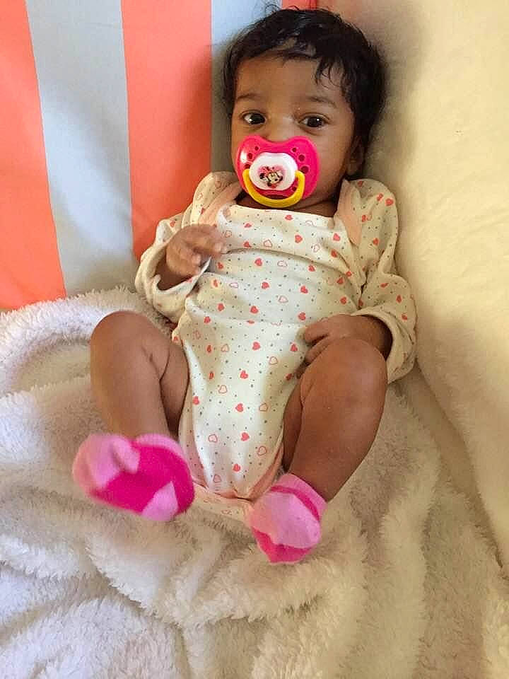 Kamilayh is registered to the contest to win money with this photo: arm, baby, baby_toddler_clothing, cheek, comfort, dress, finger, foot, happy, head, human_leg, knee, nail, person, pink, skin, sleeve, thigh, thumb, toddler