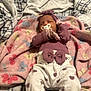 baby, pacifier, sleeping, blanket, butterfly_pattern, headband, purple_clothing, heart_pattern, infant, bedspread, plaid, cozy, gloves, cute, soft, newborn, indoor, resting, clothing, child