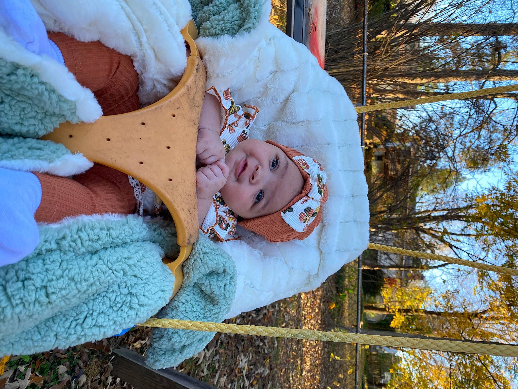 Aleigha is registered to the contest to win money with this photo: baby, child, comfort, fun, fur, grass, happy, hat, headwear, leaf, leisure, linens, nap, people_in_nature, person, plant, sky, smile, toddler, tree