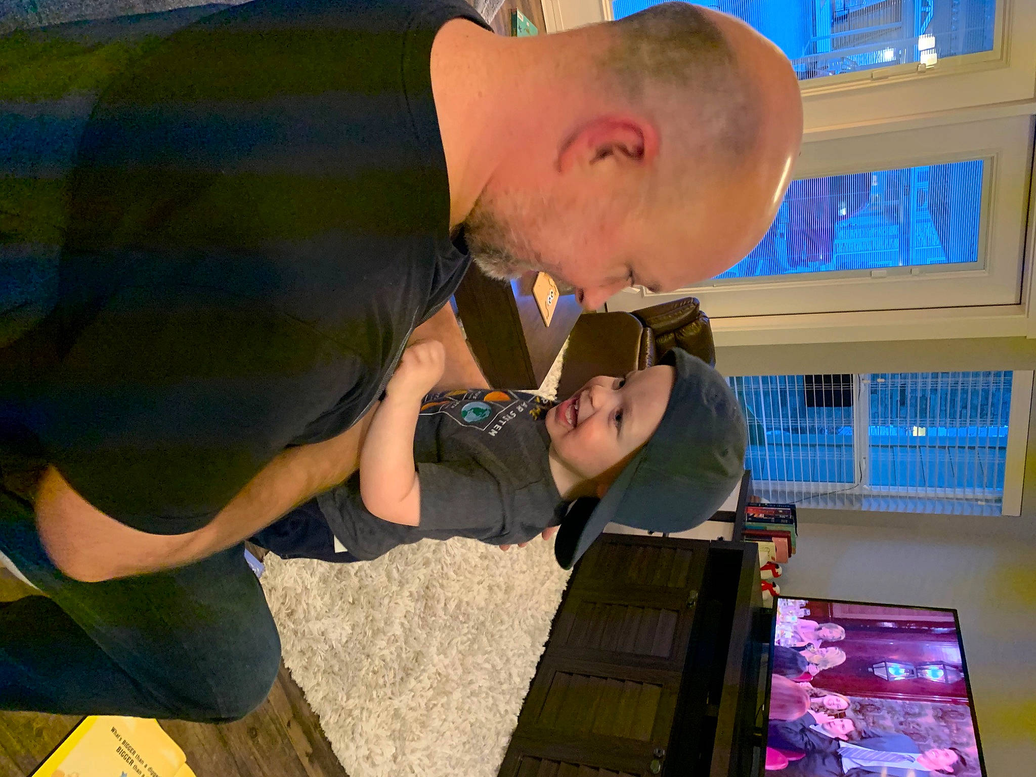 Benjamin is registered to the contest to win money with this photo: blurred, child, electronic_device, fun, headwear, person, photography, technology, toddler