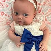 Avalynn joined the competition — help win amazing prizes! baby, infant, dress, bow, headband, lace, blanket, floral_pattern, cute, wide_eyes, pink, white, blue, portrait, child, small_hands, lying_down, soft_texture, indoors, closeup