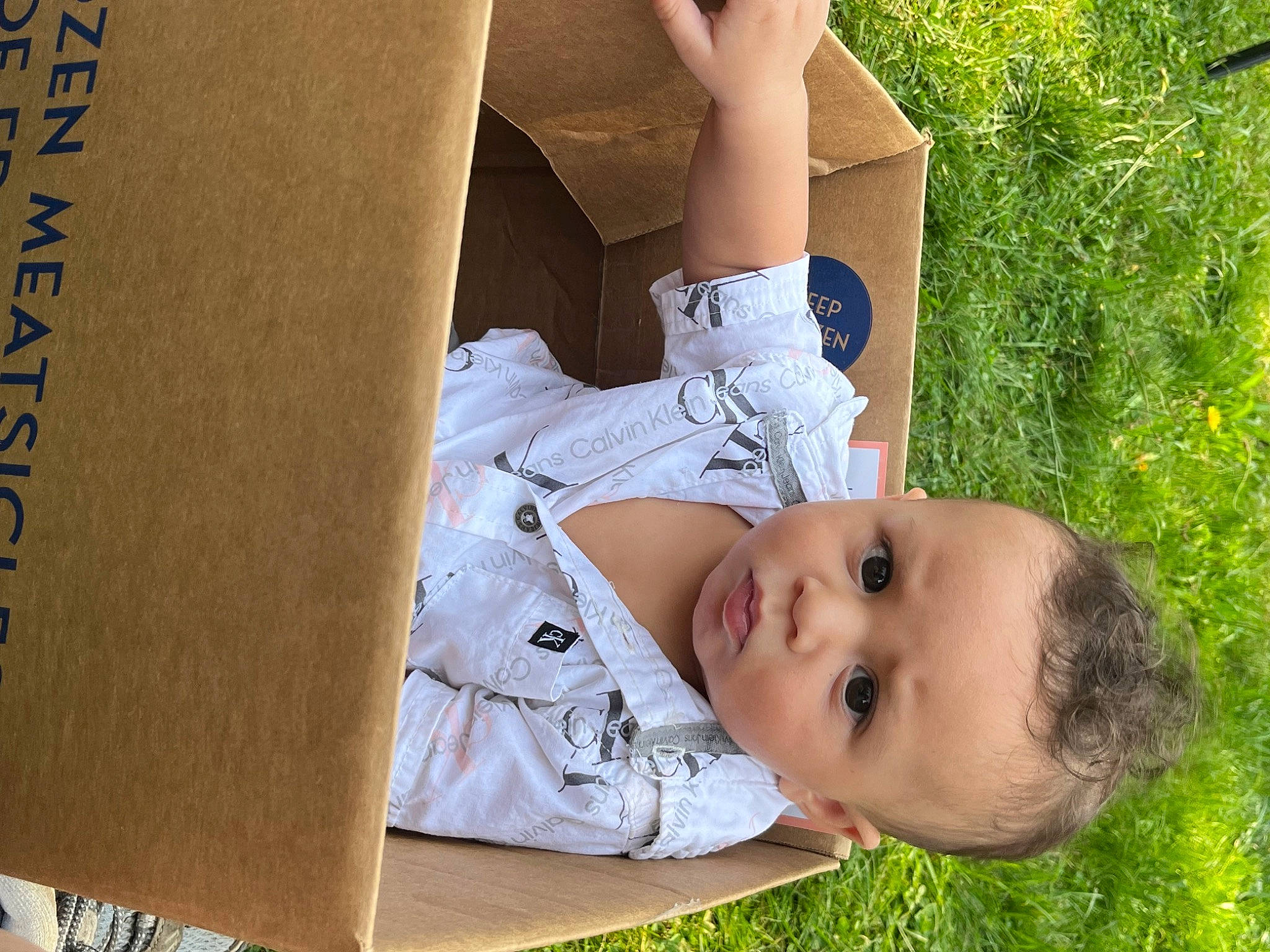 Amari is registered to the contest to win money with this photo: baby, baby_toddler_clothing, beauty, child, comfort, facial_expression, grass, happy, human_body, human_leg, knee, leisure, people_in_nature, person, plant, sitting, thigh, toddler, tree, window