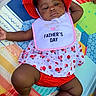 Hunter Elyza joined the competition — help win amazing prizes! baby, infant, child, portrait, lying_down, sunhat, red_hat, bib, fathers_day, strawberry_pattern, dress, colorful, play_mat, blanket, indoor, relaxed, dark_skin, smiling, cute, photography