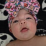 baby, child, face, headband, bow, pink, colorful, expression, cute, skin, portrait, lying_down, blanket, pattern, skull, black_and_white, eyes, mouth, infant, adorable