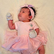 Layna Michaella joined the competition — help win amazing prizes! adorable, baby, blanket, child, colorful, cozy, cute, headband, indoors, infant, lying_down, mittens, pink_dress, portrait, sleepwear, small, socks, soft_texture, tutu, young