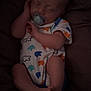 baby, sleeping, pacifier, onesie, colorful_clothing, infant, foot, hand, blanket, soft, peaceful, portrait, child, rest, cute, small, person, indoor, newborn, relaxed