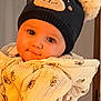 adorable, baby, bear_hat, child, childhood, cozy, cute, face, hat, holding, human, indoor, infant, person, portrait, smiling, soft_lighting, warm_clothing, winter_wear, young