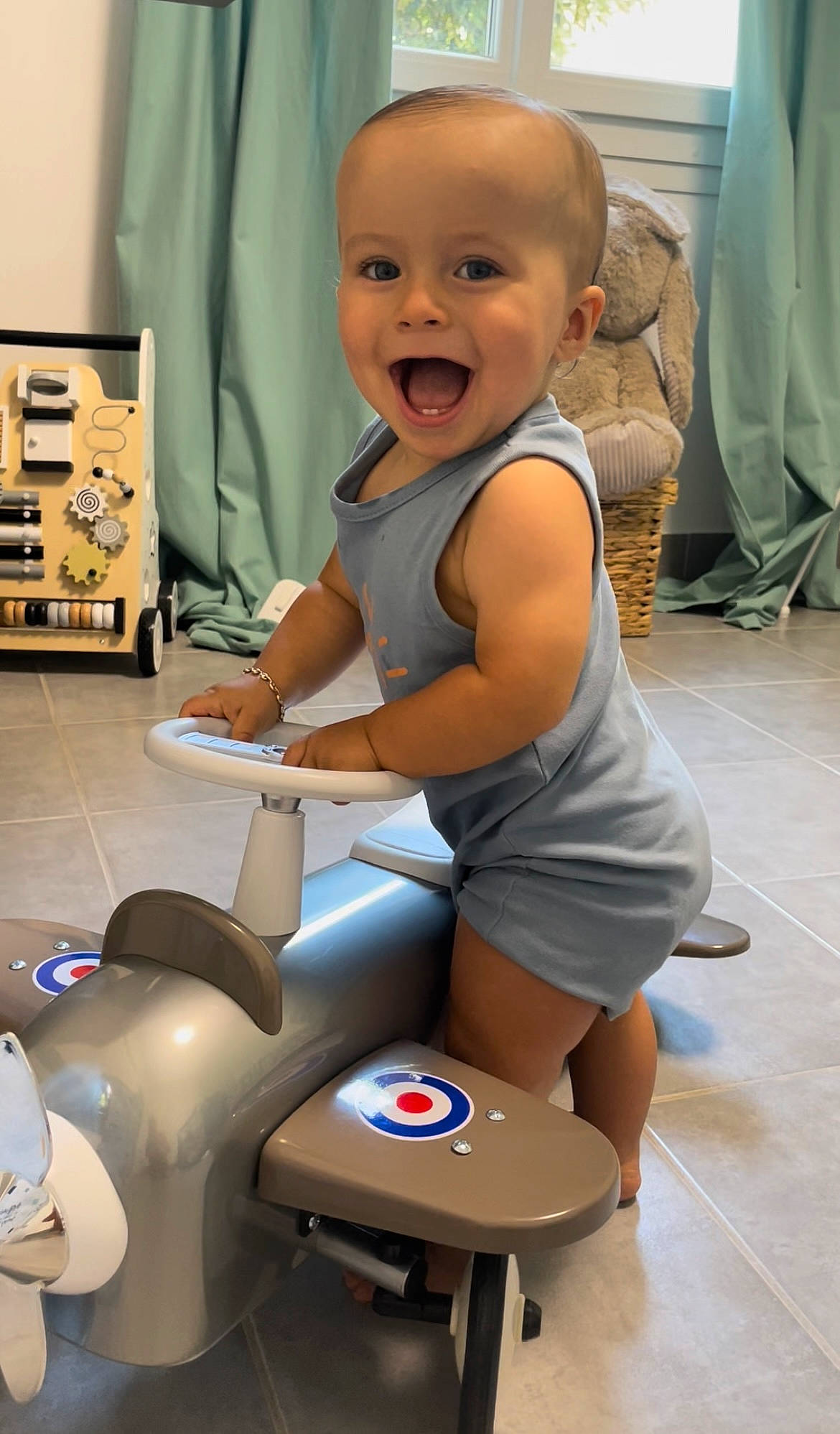Maylone participe au concours pour gagner de l'argent avec cette photo : baby, baby_toddler_clothing, cheek, child, flooring, gas, hairstyle, human_leg, joint, knee, machine, person, product, room, sitting, skin, smile, standing, thigh, toddler
