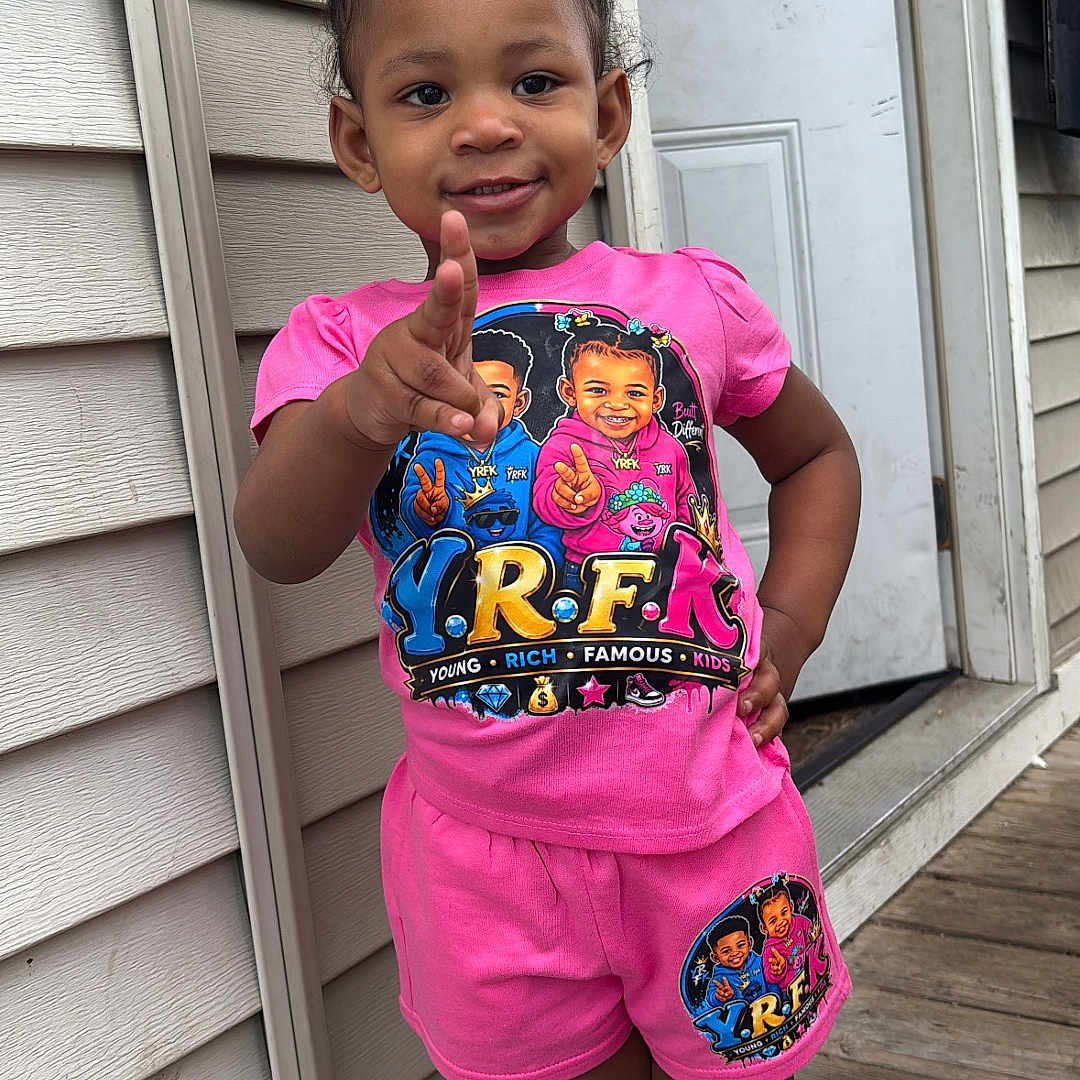 Legend Amor joined the competition — help win amazing prizes! child, toddler, girl, portrait, smiling, peace_sign, standing, outdoor, porch, door, house, siding, wooden_floor, pink_clothing, shorts, t_shirt, pigtails, barefoot, fashion, daylight