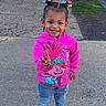 Legend Amor is registered to the contest to win money with this photo: child, toddler, girl, smiling, happy, peace_sign, portrait, outdoor, sidewalk, street, pink_sweatshirt, cartoon, hair_bows, braids, jeans, pink_shoes, clogs, standing, daylight, urban
