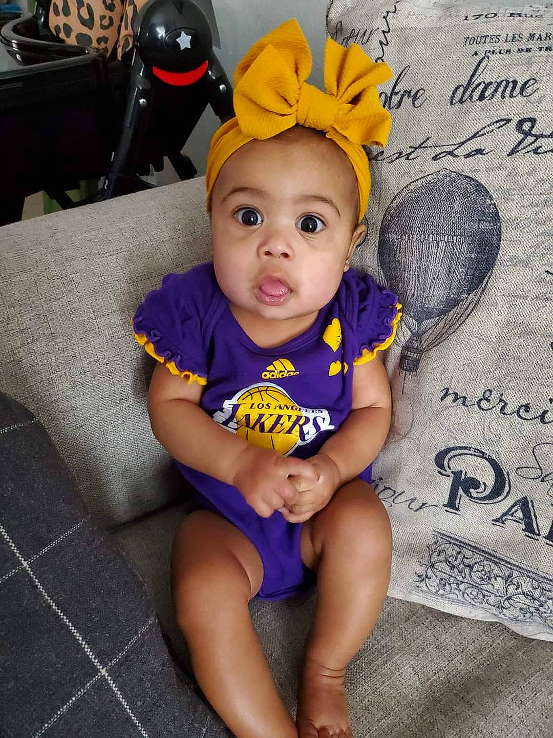 Nova is registered to the contest to win money with this photo: arm, baby, baby_toddler_clothing, chair, child, costume_hat, finger, fun, hairstyle, happy, head, mammal, organ, people, person, sitting, sleeve, surprise, t_shirt, textile