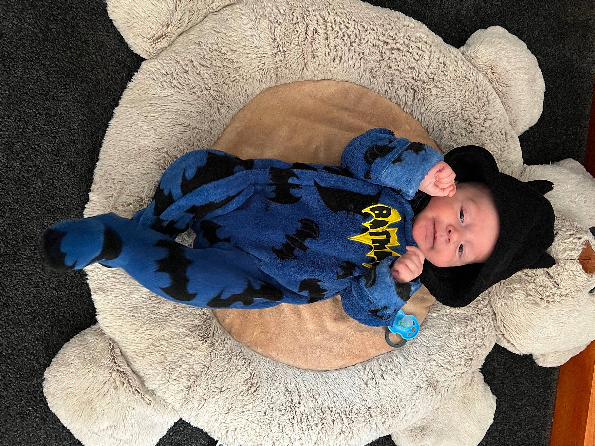 Patrick is registered to the contest to win money with this photo: arm, baby, baby_products, baby_sleeping, baby_toddler_clothing, child, comfort, electric_blue, hand, headgear, headwear, human_body, linens, mammal, outerwear, pattern, person, sitting, sleeve, sock