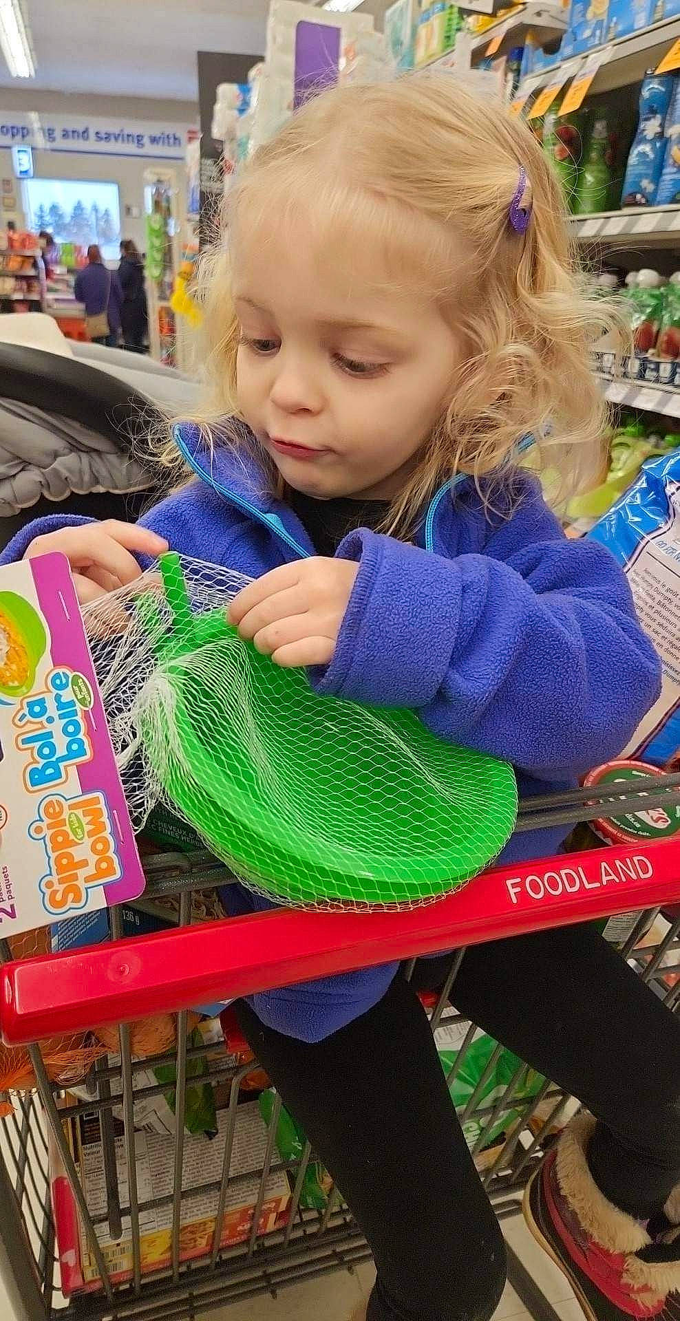 Nova is registered to the contest to win money with this photo: baby, baby_toddler_clothing, blue, child, customer, event, fun, leisure, market, marketplace, pattern, person, photograph, play, recreation, retail, service, shopping, shopping_cart, snapshot