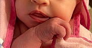 Ensley is registered to the contest to win money with this photo: baby, child, closeup, cute, expression, face, hand, hooded_towel, indoor, infant, newborn, person, pink, portrait, skin, sleepwear, soft, towel, wrapped, young