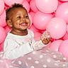 Sa'Ryiiah is registered to the contest to win money with this photo: toddler, child, smiling, happy, pink_balloons, balloons, cake_pop, dessert, white_top, polka_dot_skirt, sitting, cute, celebration, party, indoors, portrait, joyful, face, dimple, fun