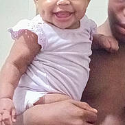 Sa'Ryiiah is registered to the contest to win money with this photo: baby, child, smiling, holding, person, adult, white_clothing, indoor, portrait, happy, cute, infant, skin, face, arm, hand, toddler, human, people, closeup