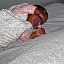 Eliyah participe au concours pour gagner de l'argent avec cette photo : baby, bedding, blanket, child, cozy, crib, cute, face, hand, indoor, infant, newborn, pacifier, person, pink_clothing, polka_dot, resting, sleep_sack, sleeping, soft_toys