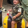 Alexander joined the competition — help win amazing prizes! anklet, barefoot, bee_toy, camouflage_clothing, child, cute, face, foot, hand, happy, hat, outdoor, person, play, ride_on_toy, shorts, smiling, toddler, toy, vest