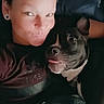 person, dog, face, tongue, smile, couch, blanket, indoor, casual, relaxed, snuggling, pet, companion, portrait, closeup, human, animal, friendship, comfort, happy