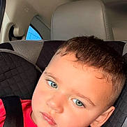 Jayden is registered to the contest to win money with this photo: blue_eyes, car_interior, car_seat, child, child_seat, cute, expression, face, hair, head, indoors, person, portrait, red_shirt, restraint, safety, seat, seat_belt, window, young