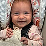 baby, smiling, blanket, car_seat, infant, cute, child, happy, clothing, fabric, pattern, indoors, portrait, face, hands, warm, cozy, blue_eyes, knit, seatbelt
