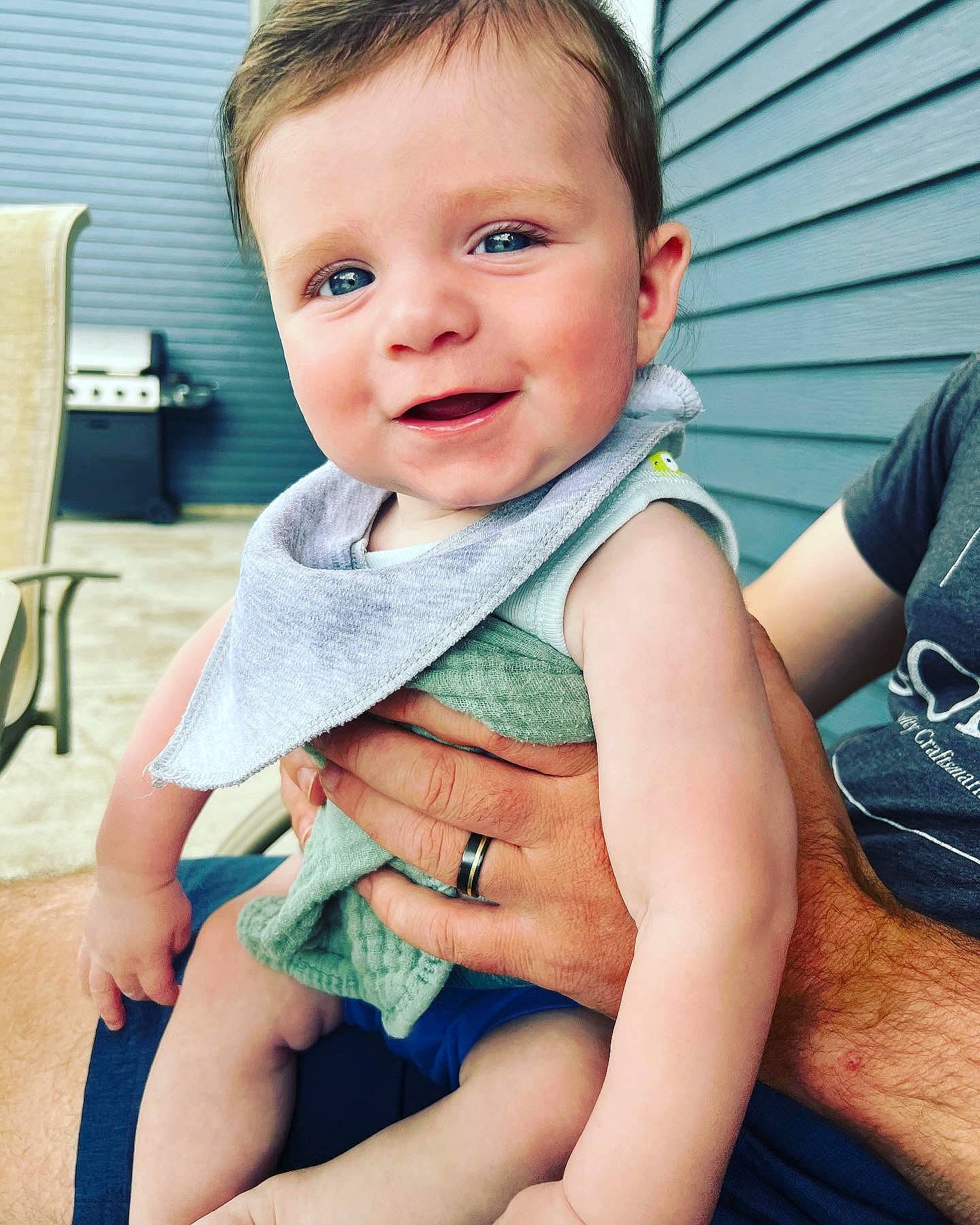 Stanton is registered to the contest to win money with this photo: abdomen, baby, baby_toddler_clothing, chair, cheek, child, eye, facial_expression, happy, human_leg, iris, joy, neck, pattern, person, skin, sleeve, smile, thigh, thumb