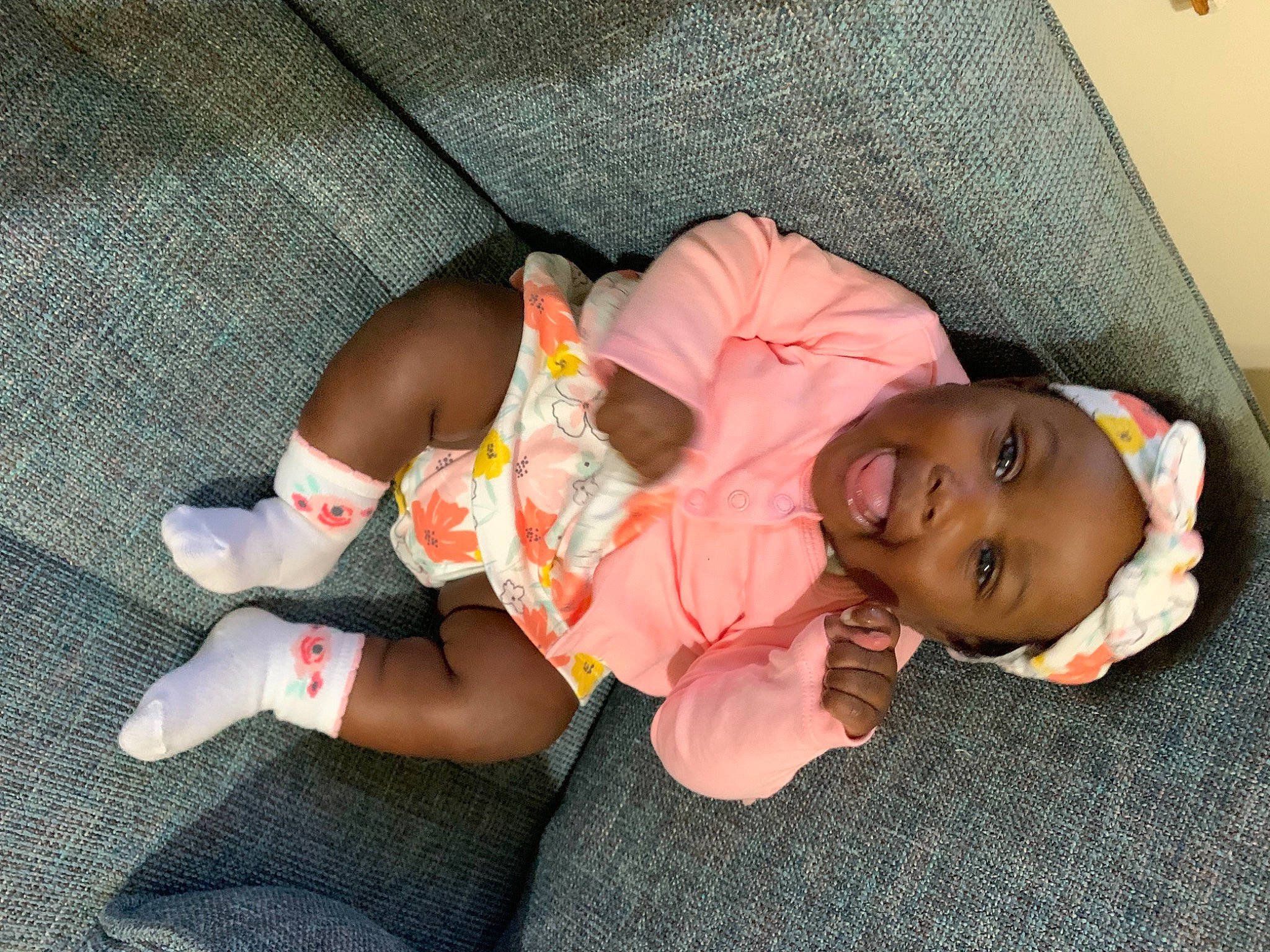 Ariya is registered to the contest to win money with this photo: baby, baby_products, baby_toddler_clothing, bedtime, child, comfort, finger, foot, grass, head, headwear, human_leg, knee, lap, leg, person, sitting, skin, sock, thigh