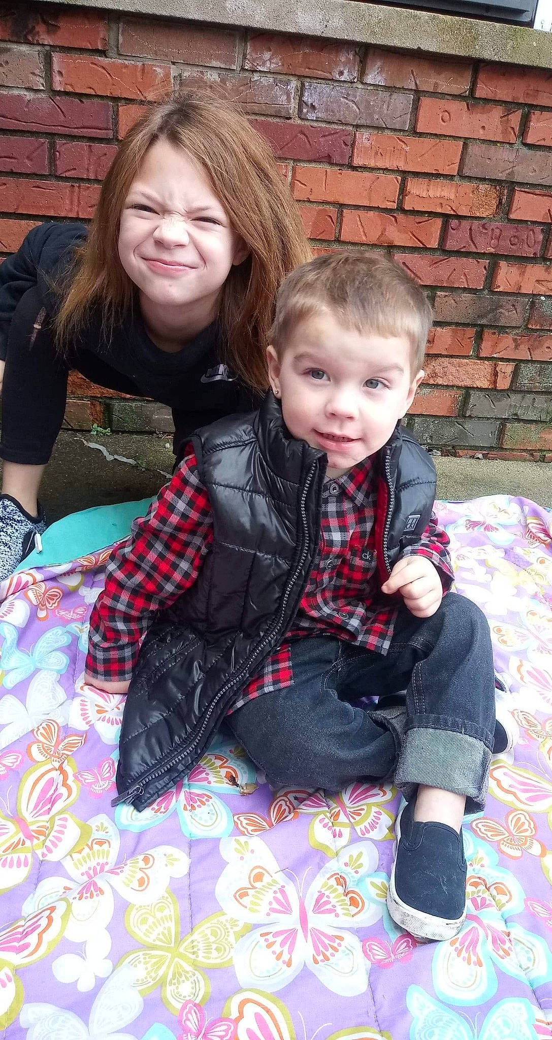 Javier joined the competition — help win amazing prizes! anger, child, daughter, design, joy, pattern, people, person, plaid, sibling, sitting, smile, toddler