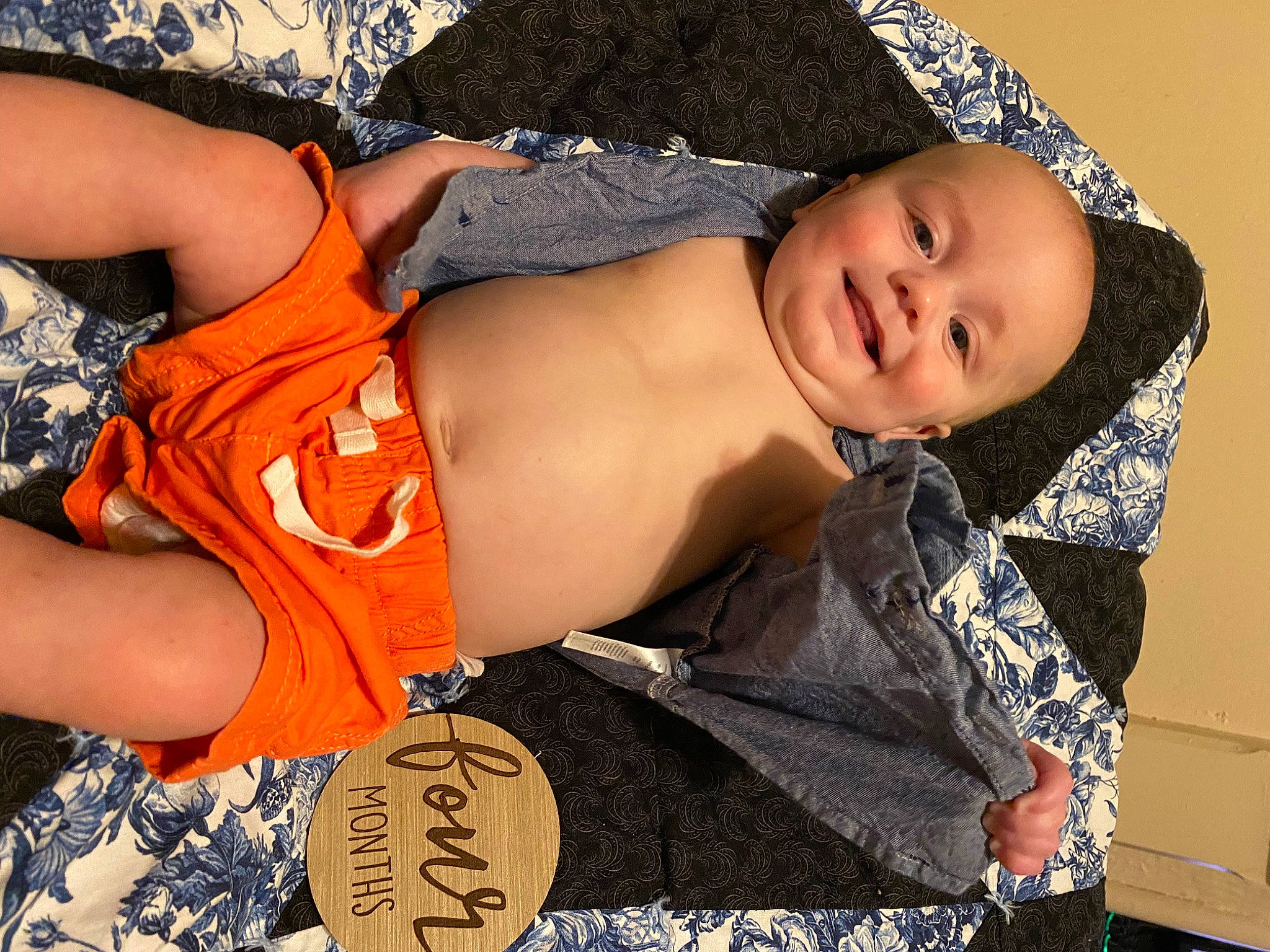 Lane is registered to the contest to win money with this photo: abdomen, black_hair, chest, dress, elbow, glasses, hand, happy, human_body, joint, joy, leg, neck, orange, person, shoulder, stomach, textile, thigh, toddler