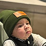Guilherme participe au concours pour gagner de l'argent avec cette photo : baby, child, face, hat, beanie, clothing, jacket, indoor, portrait, cute, pout, expression, young, person, headwear, warm_clothing, skin, eyes, cheeks, blurred_background