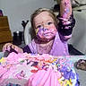 Iris joined the competition — help win amazing prizes! child, toddler, birthday, cake, frosting, pink, purple, messy, smiling, face, portrait, sitting, indoor, celebration, food, dessert, high_chair, long_sleeve, colorful, playful