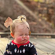 Iris joined the competition — help win amazing prizes! child, toddler, baby, portrait, pouting, serious_expression, rosy_cheeks, blonde_hair, hair_bow, topknot, outdoor, sunlight, patio, brick_wall, penguin_pattern, long_sleeves, fashion, standing, close_up, playful