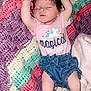 Shayann joined the competition — help win amazing prizes! baby, newborn, sleeping, arms_up, pink_onesie, unicorn, magical_text, crocheted_blanket, colorful_blanket, denim_shorts, soft_texture, infant, peaceful, closed_eyes, cute, tiny_feet, relaxed, indoors, child, person