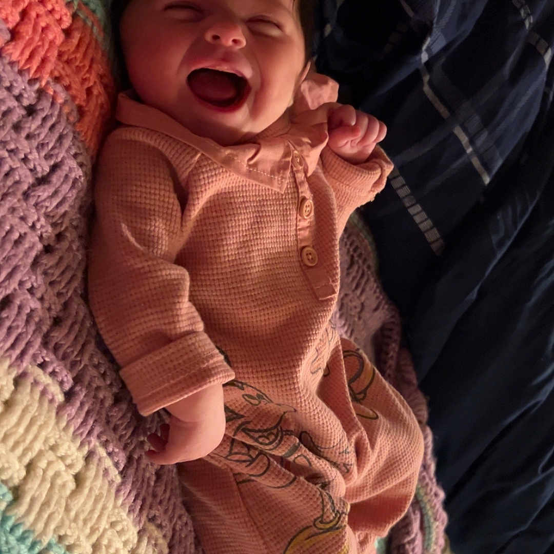 Shayann joined the competition — help win amazing prizes! baby, blanket, child, colorful, cozy, crocheted, cute, happy, indoor, infant, laughing, lying_down, onesie, person, portrait, sleepwear, smiling, soft, warm, young