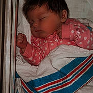 Shayann is registered to the contest to win money with this photo: baby, sleeping, crib, blanket, pink_clothing, polka_dot, infant, cozy, resting, cute, newborn, wrapped, soft, peaceful, child, indoors, portrait, clothing, bed, baby_bed