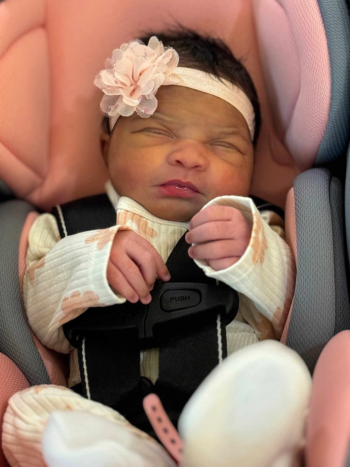 Desiree joined the competition — help win amazing prizes! baby, infant, car_seat, headband, flower, sleeping, pink, white, hands, clothing, harness, closeup, cute, newborn, soft, seatbelt, child, person, portrait, indoor