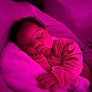 Desiree is registered to the contest to win money with this photo: baby, sleeping, blanket, infant, child, soft, cozy, pink_light, indoors, rest, peaceful, cute, hand, face, curly_hair, pajamas, portrait, resting, toddler, comfort
