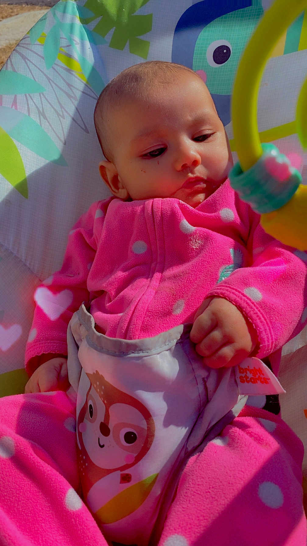 Sofía joined the competition — help win amazing prizes! baby, infant, pink_clothing, polka_dot, onesie, baby_seat, toy_ring, owl_print, hand, face, head, cute, child, young, indoor, colorful, cozy, clothing, portrait, baby_toys