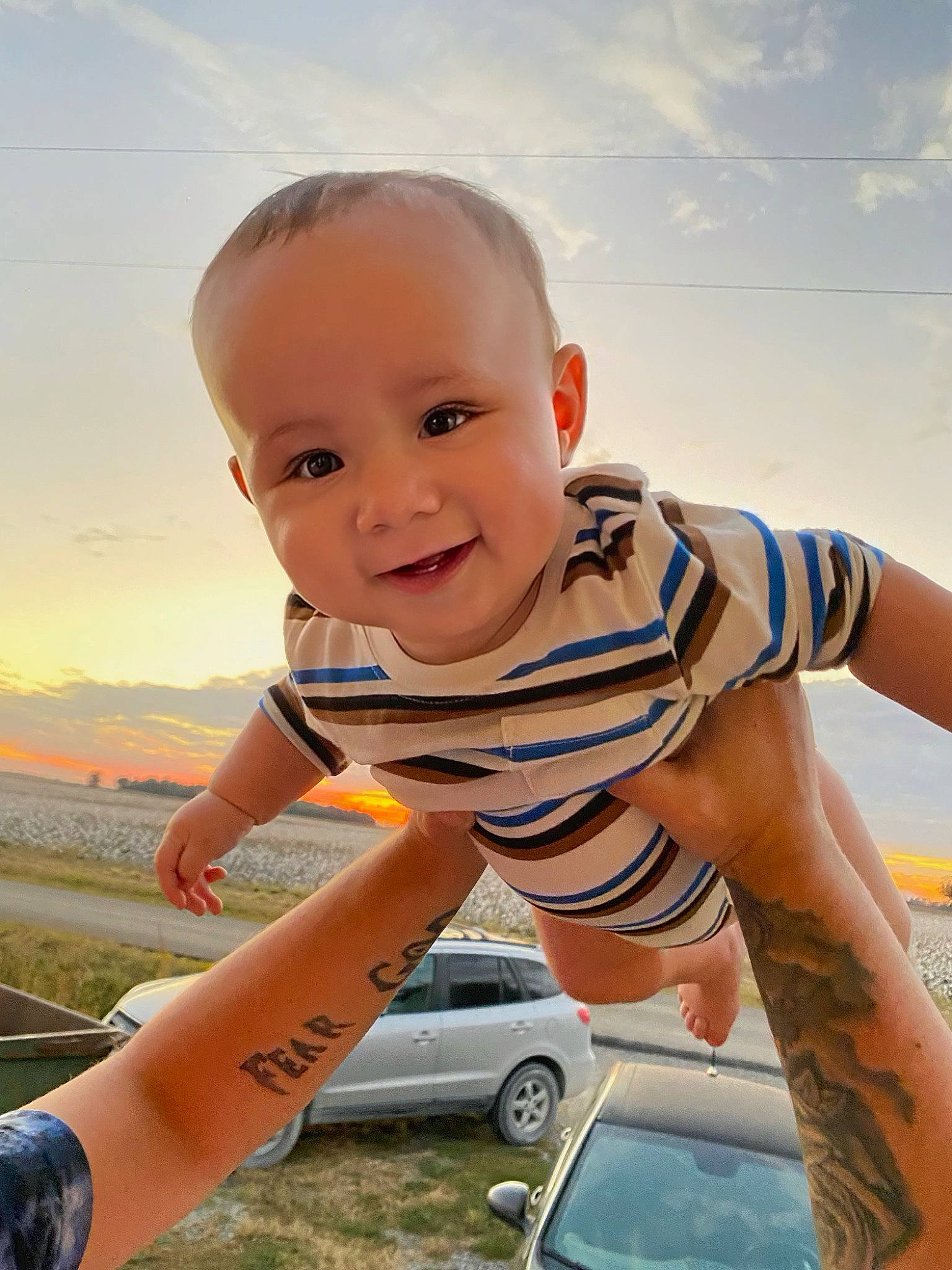 Kayson is registered to the contest to win money with this photo: baby, baby_toddler_clothing, car, cloud, cool, face, finger, flash_photography, gesture, grass, happy, joy, muscle, people_in_nature, person, photograph, skin, sky, smile, tire