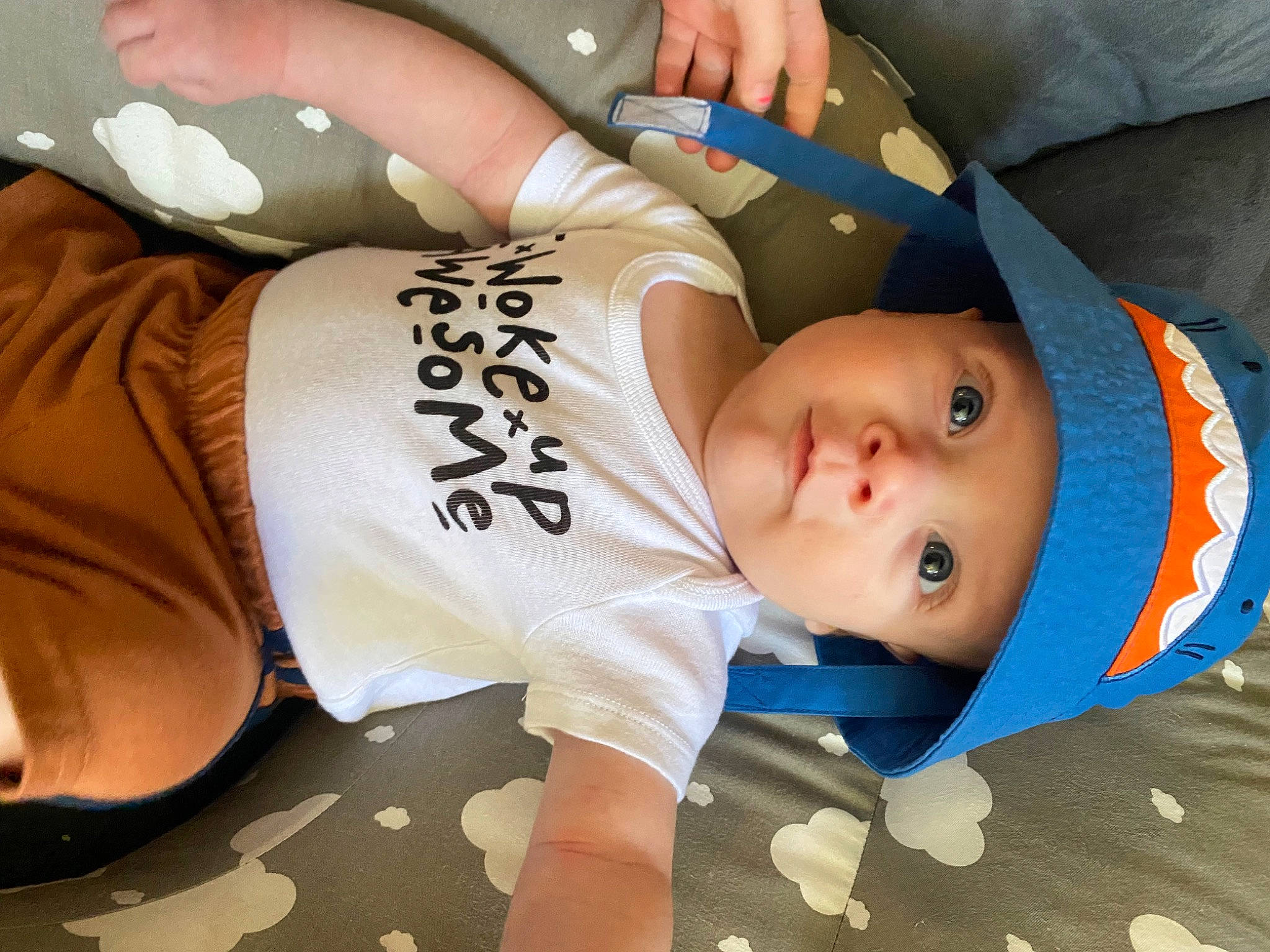 Daxton is registered to the contest to win money with this photo: abdomen, arm, baby, baby_toddler_clothing, chest, child, comfort, elbow, eye, gesture, hat, headwear, human_leg, knee, mammal, mouth, person, thigh, thumb, toddler