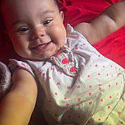 Amayathist is registered to the contest to win money with this photo: baby, smiling, infant, cute, child, face, arm, clothing, white, pink, hearts, stuffed_animal, toy, red_background, lying_down, portrait, happy, closeup, skin, cheeks