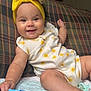 Amayathist is registered to the contest to win money with this photo: baby, infant, smiling, yellow_headband, sun_pattern, plaid_couch, colorful_book, blanket, indoors, cute, happy, child, playful, portrait, clothing, hand, foot, face, pacifier, relaxed