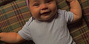 Amayathist joined the competition — help win amazing prizes! baby, smiling, plaid_couch, purple_headband, flower_accessory, leopard_print_pants, infant, happy, cute, lying_down, indoors, pacifier, child, portrait, clothing, headwear, furniture, patterned, cozy, toddler