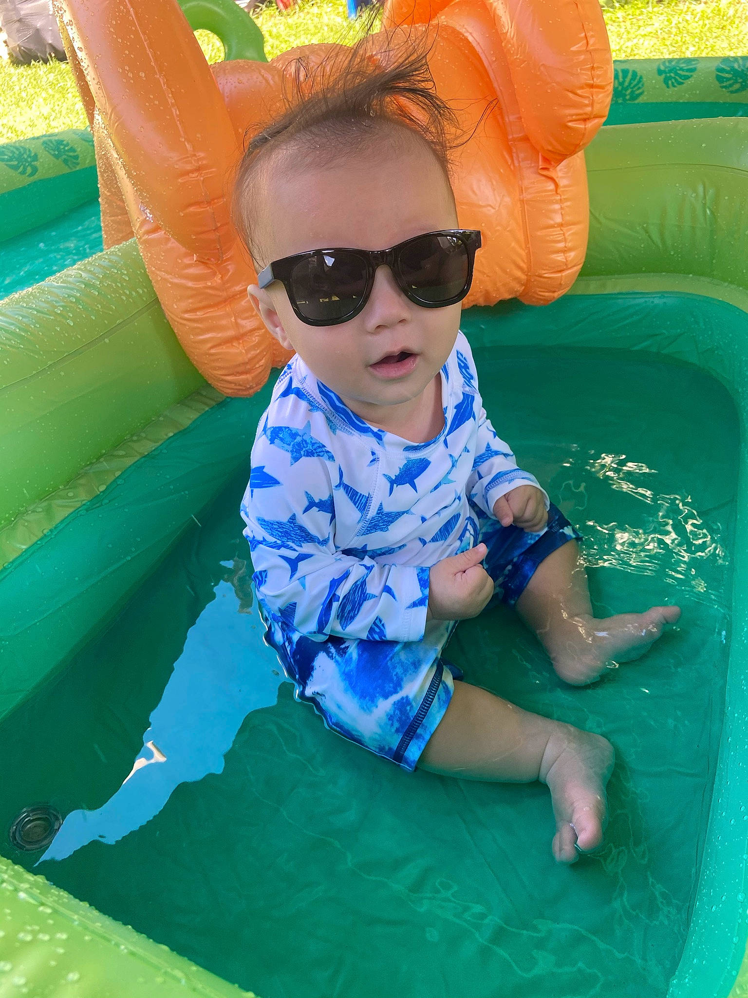 Neo Reeves is registered to the contest to win money with this photo: aqua, azure, baby_toddler_clothing, blue, child, comfort, facial_expression, fun, goggles, grass, green, happy, leisure, person, photograph, recreation, summer, sunglasses, toddler, water