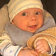 Asher joined the competition — help win amazing prizes! baby, infant, hat, blanket, clothing, hand, face, portrait, cute, smile, child, person, warm, cozy, soft, expression, indoors, newborn, wrapped, comfort