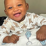 Daharei is registered to the contest to win money with this photo: baby, smiling, teddy_bear, onesie, pillow, elephant, infant, happy, cute, child, indoor, face, hands, bed, sleepwear, soft, closeup, portrait, young, playful