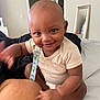 Daharei is registered to the contest to win money with this photo: baby, smile, infant, indoor, bed, clothing, mirror, room, furniture, skin, expression, person, happy, hand, foot, pacifier_clip, diaper, open_door, blanket, casual
