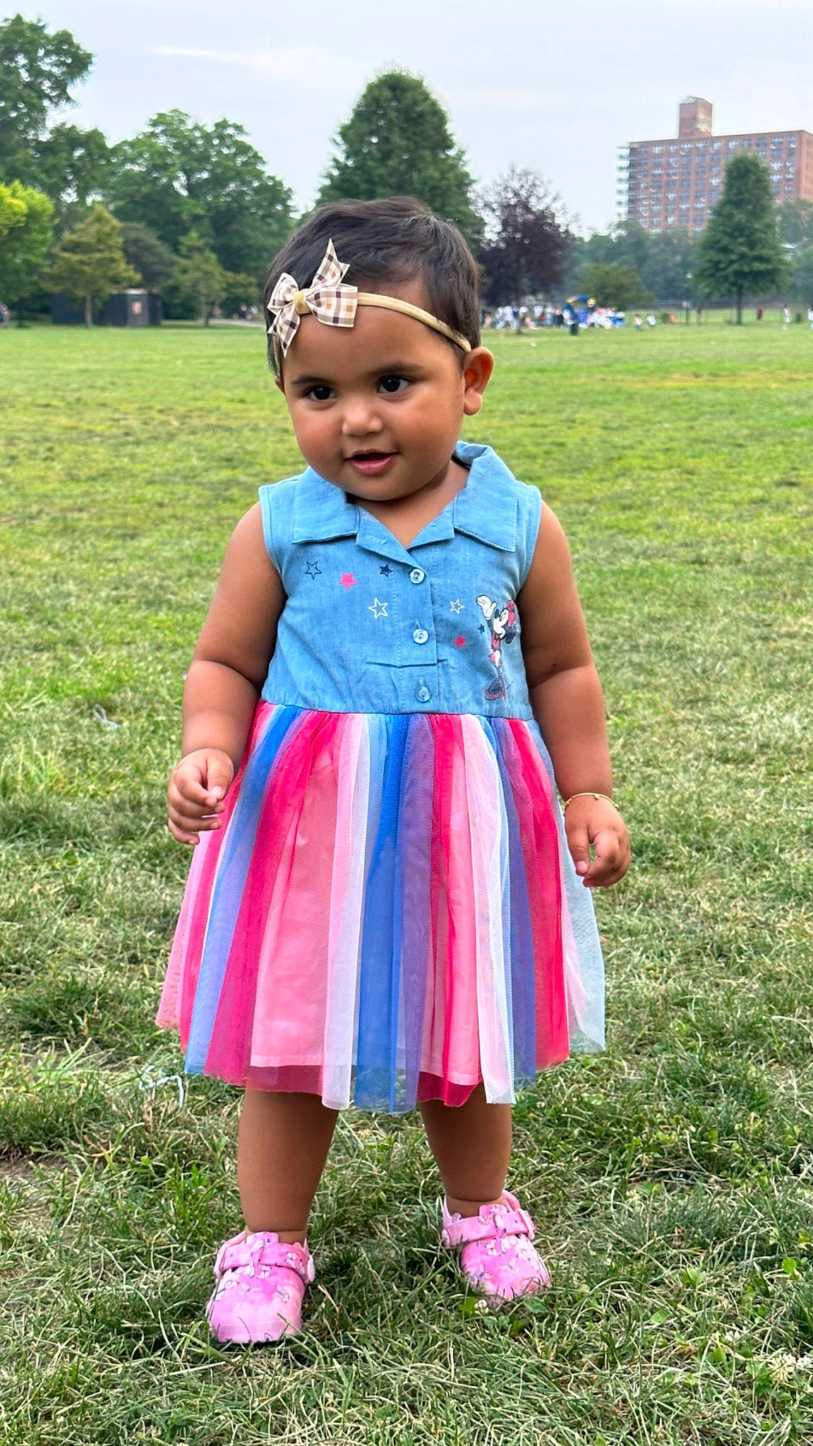 Madina is registered to the contest to win money with this photo: baby_toddler_clothing, day_dress, dress, electric_blue, eye, fun, grass, grass_family, grassland, happy, headwear, lawn, leisure, magenta, meadow, people_in_nature, person, pink, plant, sky