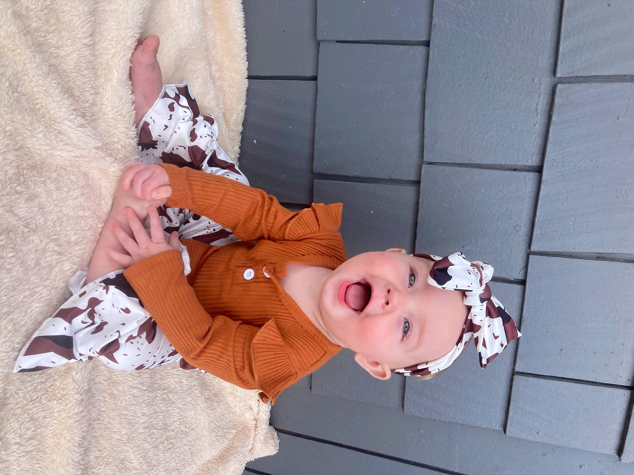 Emilie joined the competition — help win amazing prizes! baby, baby_toddler_clothing, carmine, child, doll, flooring, hand, happy, hat, headwear, human_leg, pattern, peach, person, pink, sleeve, smile, textile, toddler, toy